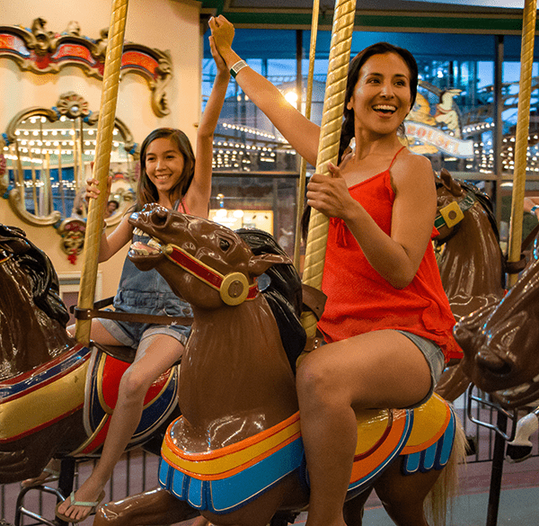 mom and daughter on carousel